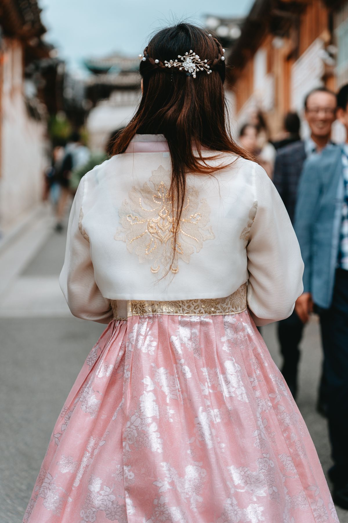 Woman in traditional Korean hanbok walking in a Seoul street - the cultural identity behind K-beauty