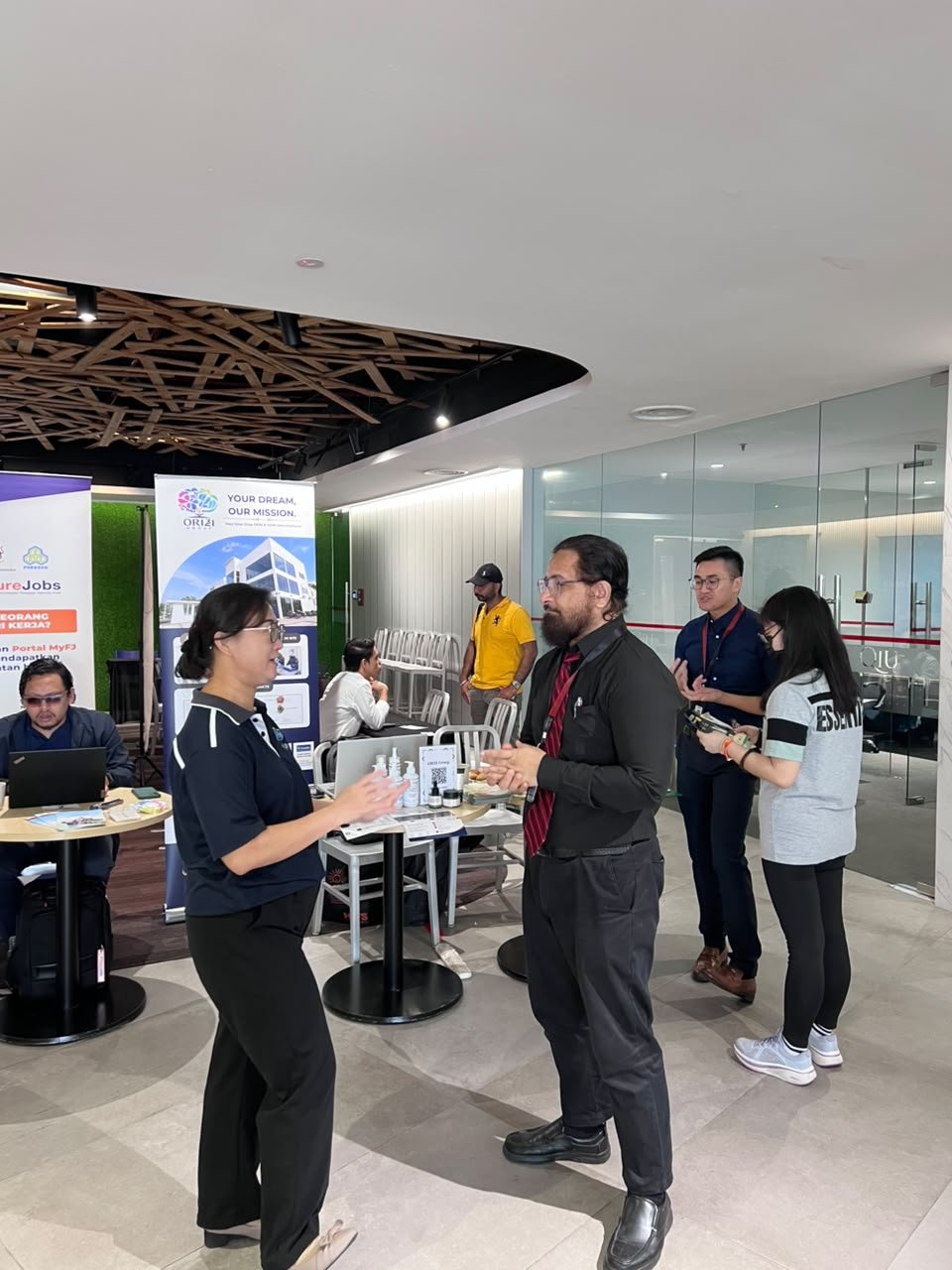 ORIZI Group team speaking with visitors at the QIU Industry Day 2026 booth