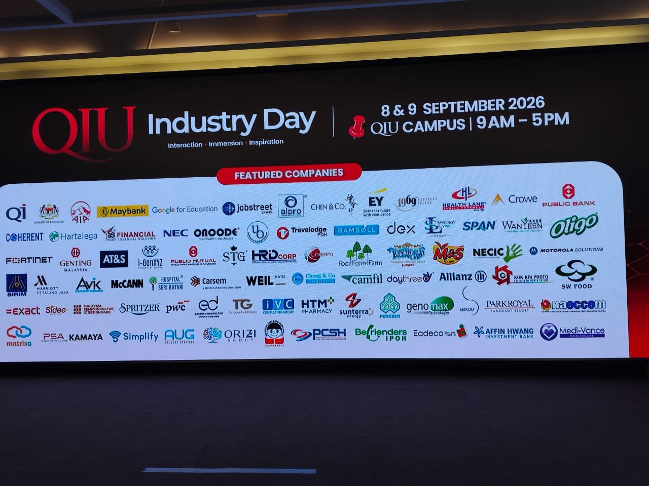 QIU Industry Day 2026 featured companies screen showing the ORIZI Group logo