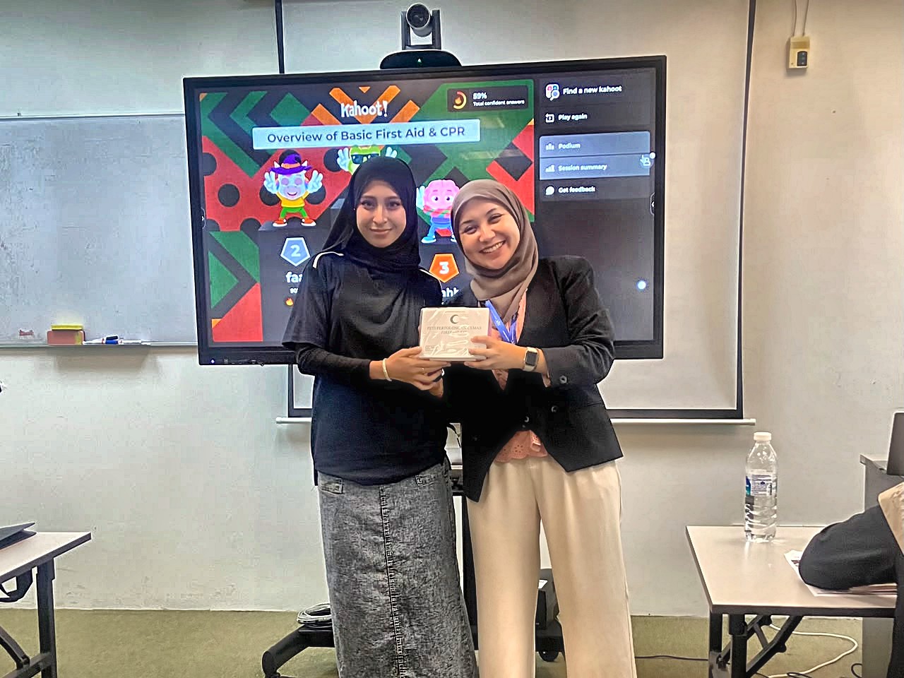Certificate and token presentation at the HRD Corp Basic Occupational First Aid training session